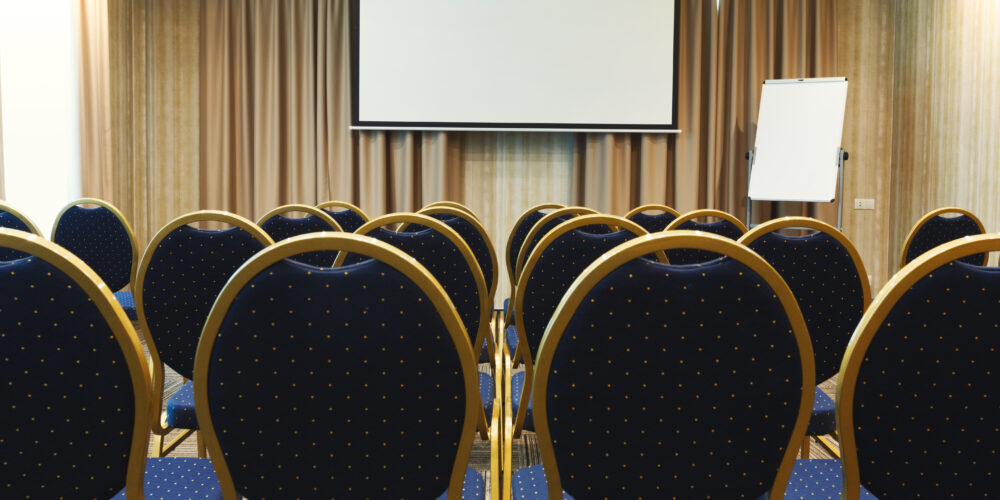 Interior of modern conference hall in contemporary hotel, perfect place for business meetings with luxury blue chairs, copy space